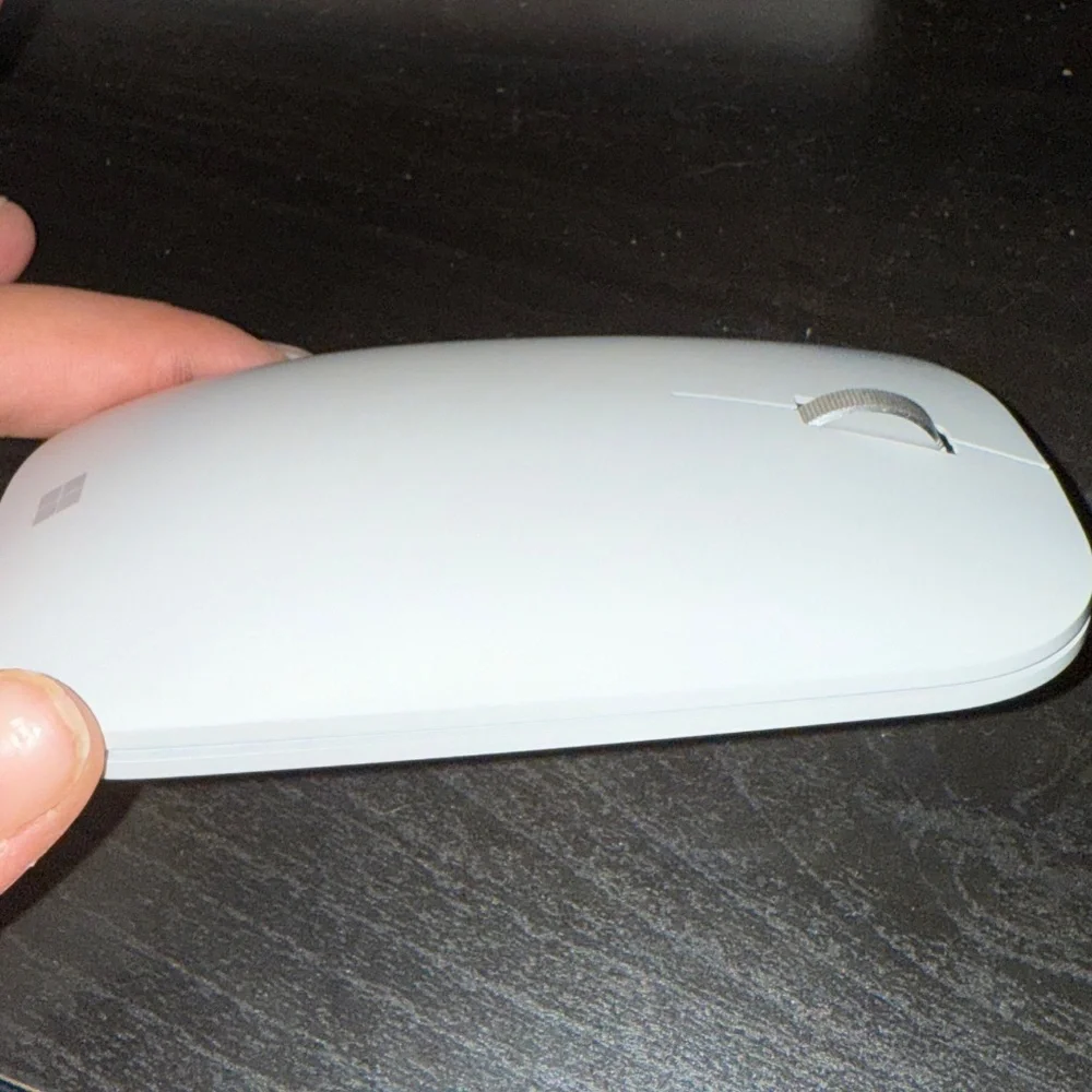 The Microsoft light grey wireless mouse